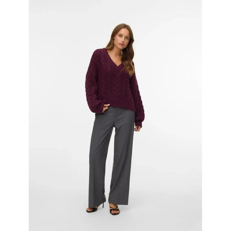 A deep burgundy cable knit v neck sweater with long sleeves paired with vero moda women grey trousers zip button regular fit