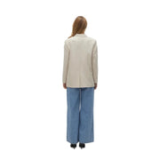 Vero moda women’s beige blazer with button and front pockets featuring tailored fit and subtle texture paired with blue wide-leg denim trousers
