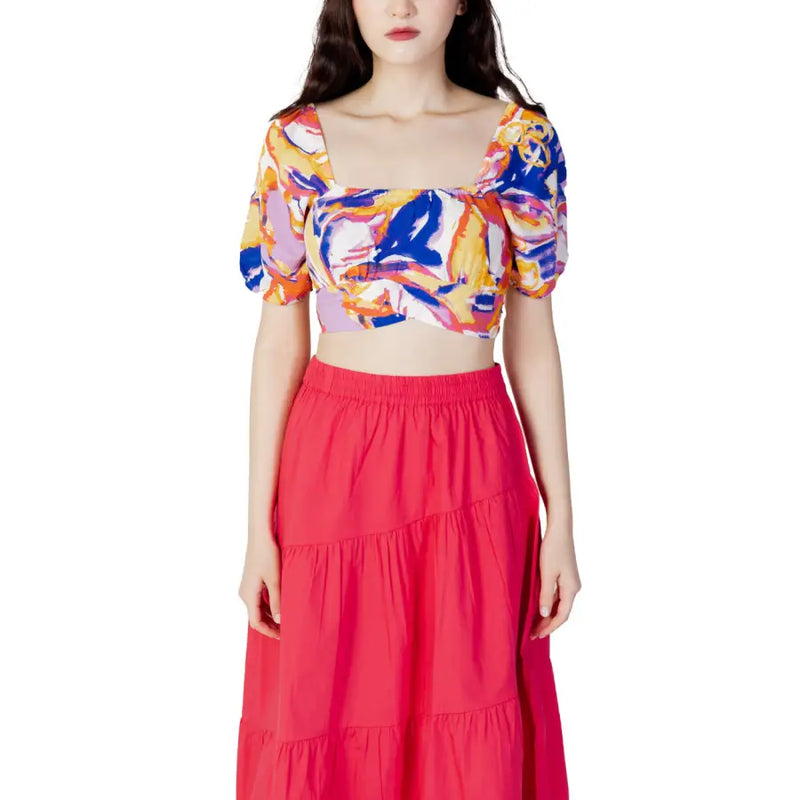 Vibrant abstract print crop top with puff sleeves paired with a red maxi skirt for women