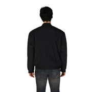 Back view of a model in a Boss Men’s Black Mandarin Jacket and faded jeans