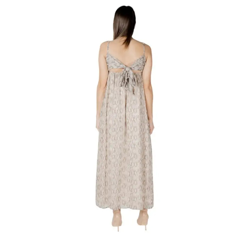 Back view of a beige patterned sleeveless maxi dress displayed in a product image