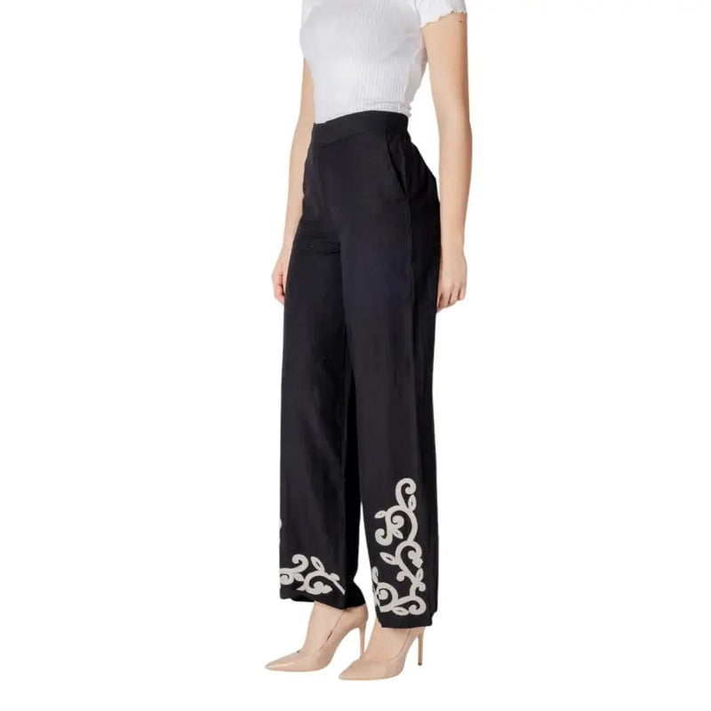 Black wide-leg Vila Clothes trousers in cotton linen viscose with elegant white embroidered floral patterns on lower legs