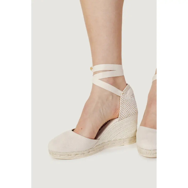 Cream-colored espadrille wedge sandals with woven jute soles and mesh heel panel for women size 6.5 shown from back