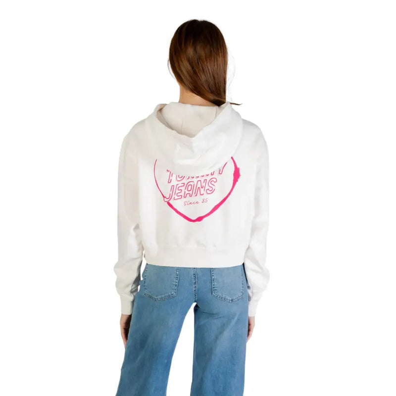 White cropped hoodie with pink heart graphic and TOMMY JEANS text on the back