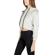 A cropped white hooded cotton blend sweatshirt for women with black drawstrings and subtle side pockets in a minimalist design