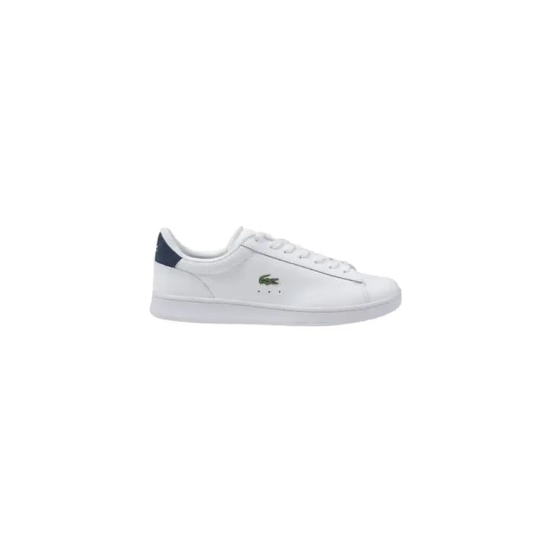 White leather Lacoste sneaker with green heel accent displaying a stylish footwear design