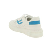 White leather sneaker with blue accents showcasing modern athletic footwear design