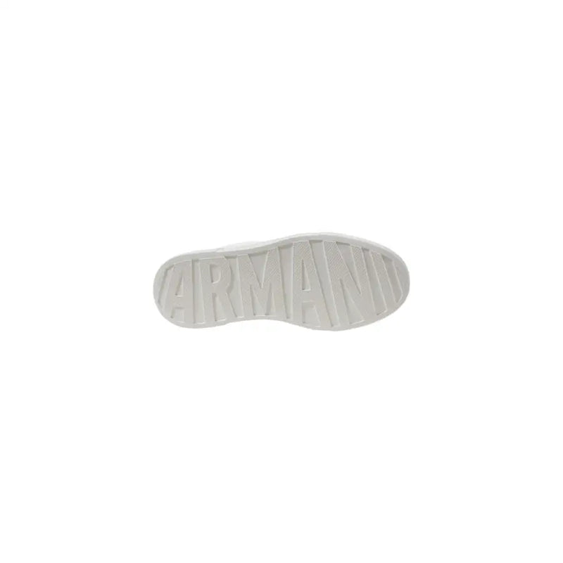 White leather sneakers with black heel accent showing the white rubber sole embossed with armani branding