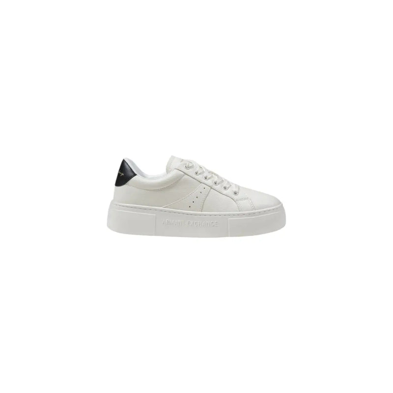 White leather low-top sneaker with black heel accent and embossed branding on the sole shown from the back side