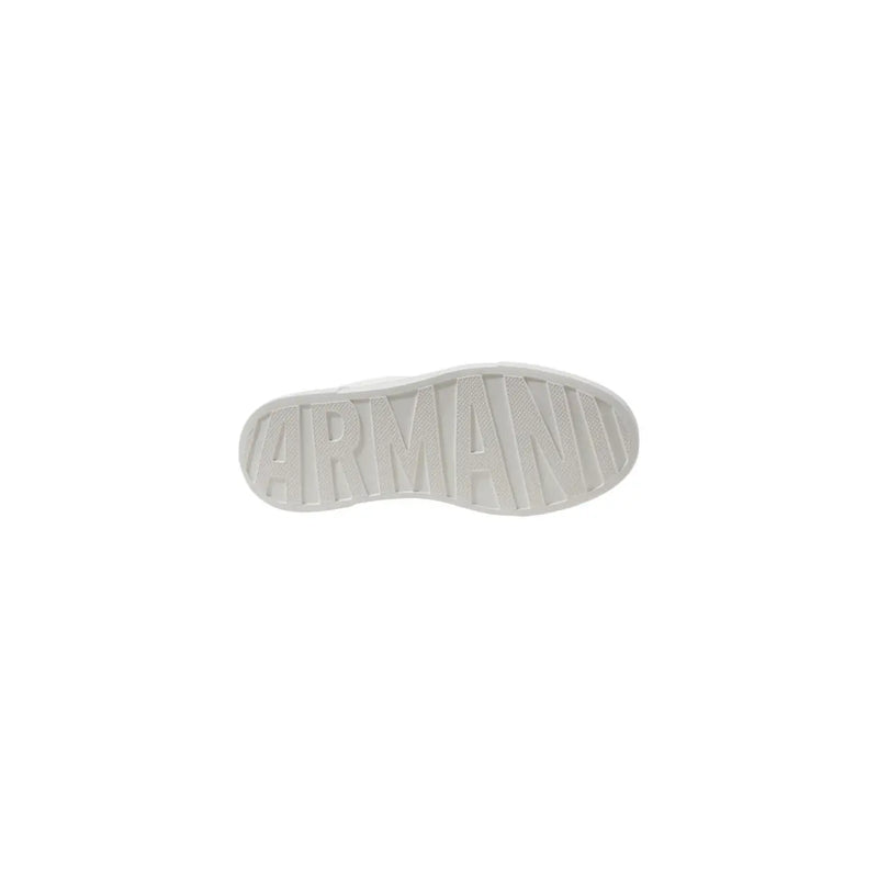 White leather sneakers with black heel accent showing the white rubber sole embossed with armani branding