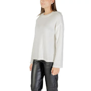 White long-sleeved fuzzy crew neck knitwear with fringed hem paired with black leather pants