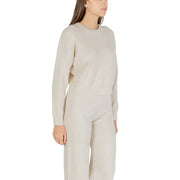 Cream-colored ribbed knit sweater for women with long sleeves and a round crew neckline