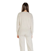 Cream-colored long sleeve round neck knit sweater for women with ribbed neckline and cuffs made of soft fabric