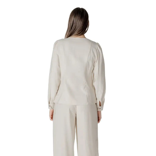Beige long-sleeved viscose blouse for women with puffed shoulders and subtle side seam detailing