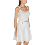 Guess White Strappy Round Neck Top paired with ribbed knit two-piece pleated skirt set with decorative buttons