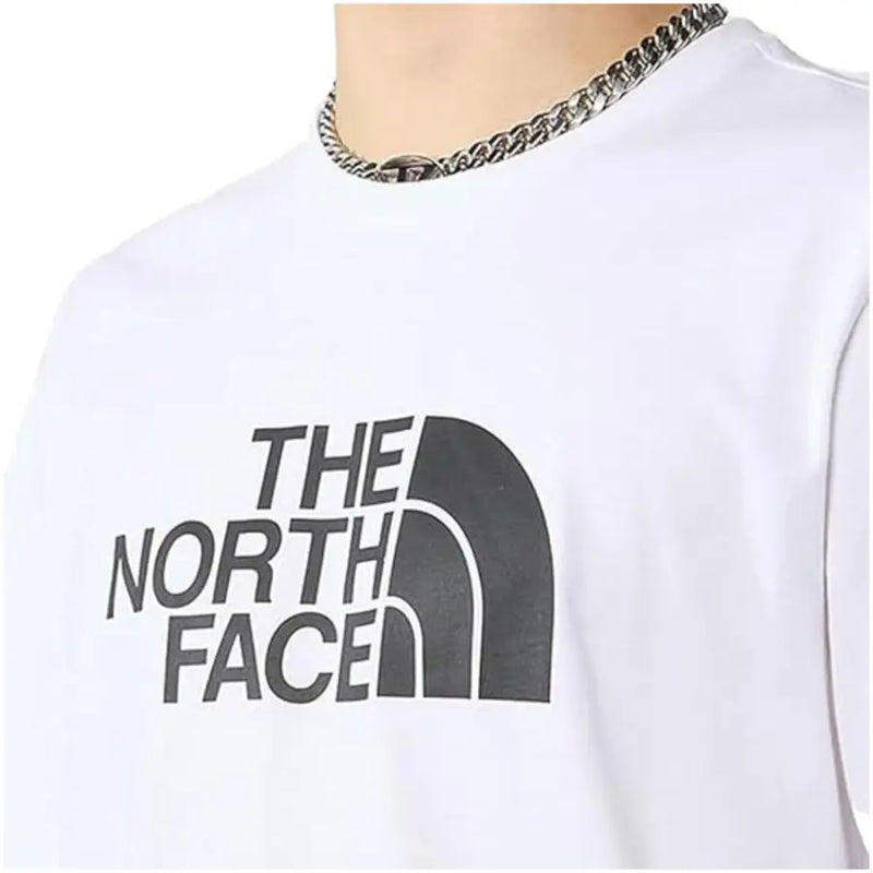 White short sleeved t shirt with The North Face logo featuring a bold black arc design on front
