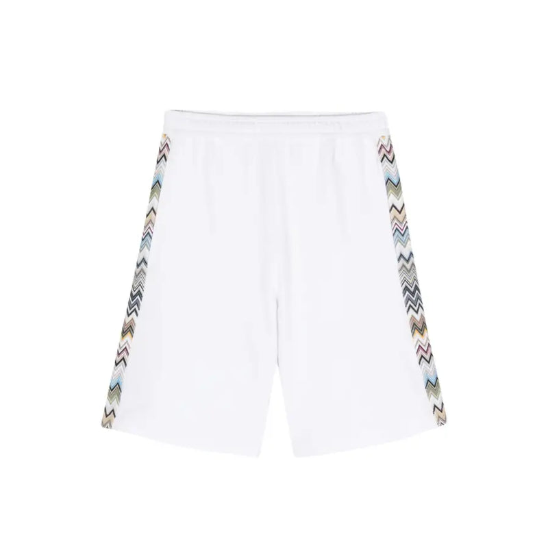White athletic shorts featuring patterned zigzag side stripes for a stylish sports look