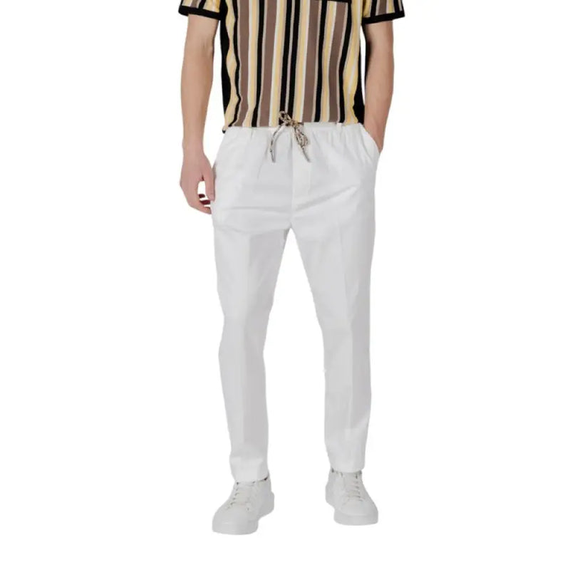 White drawstring trousers displayed in a product image showcasing stylish and comfortable design