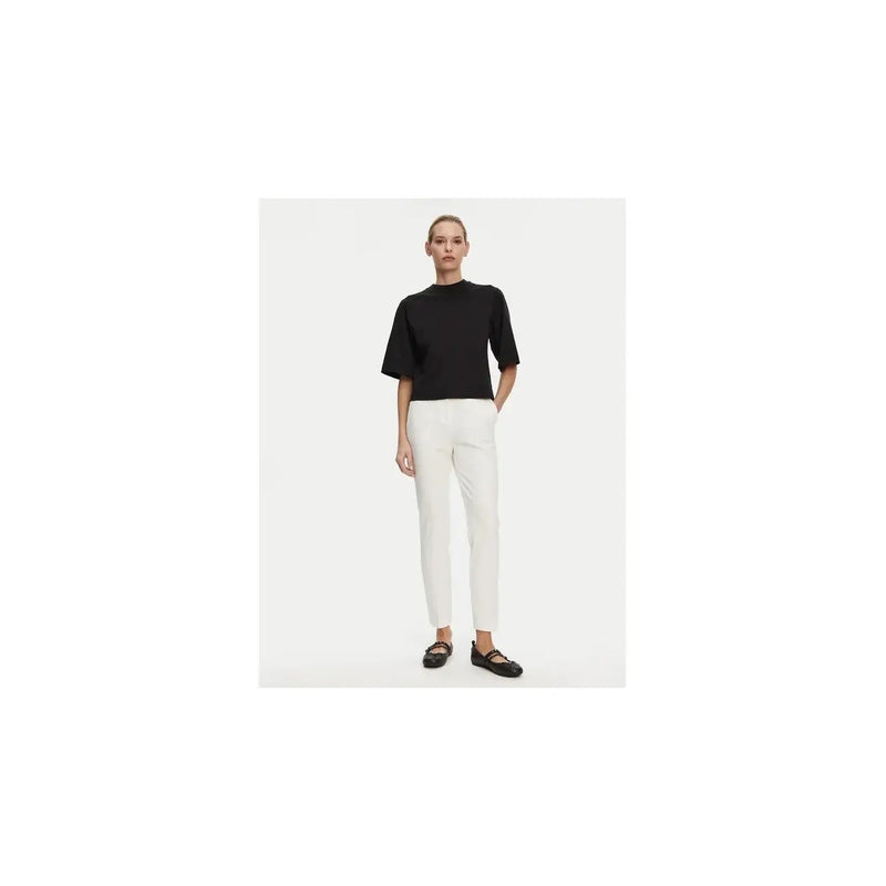 Black short-sleeved top with high neckline and relaxed fit paired with white viscose blend trousers by Pinko