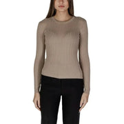 Woman in beige ribbed long-sleeve top and black pants showcasing Vila Clothes sweater