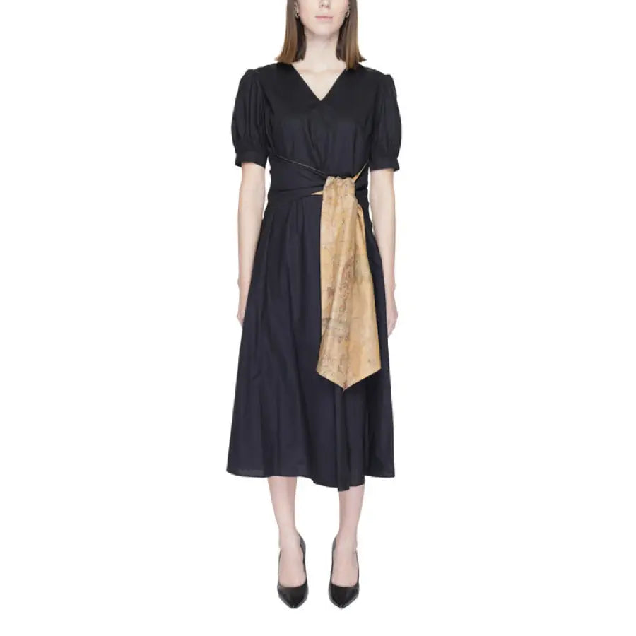 Woman wearing Alviero Martini Prima Classe black dress with brown sash
