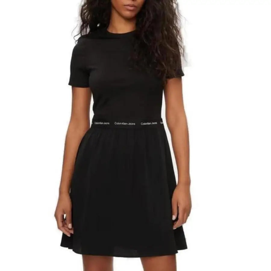 
                      
                        Woman in black Calvin Klein dress with belt, perfect for casual & formal wear - Calvin Klein Jeans
                      
                    
