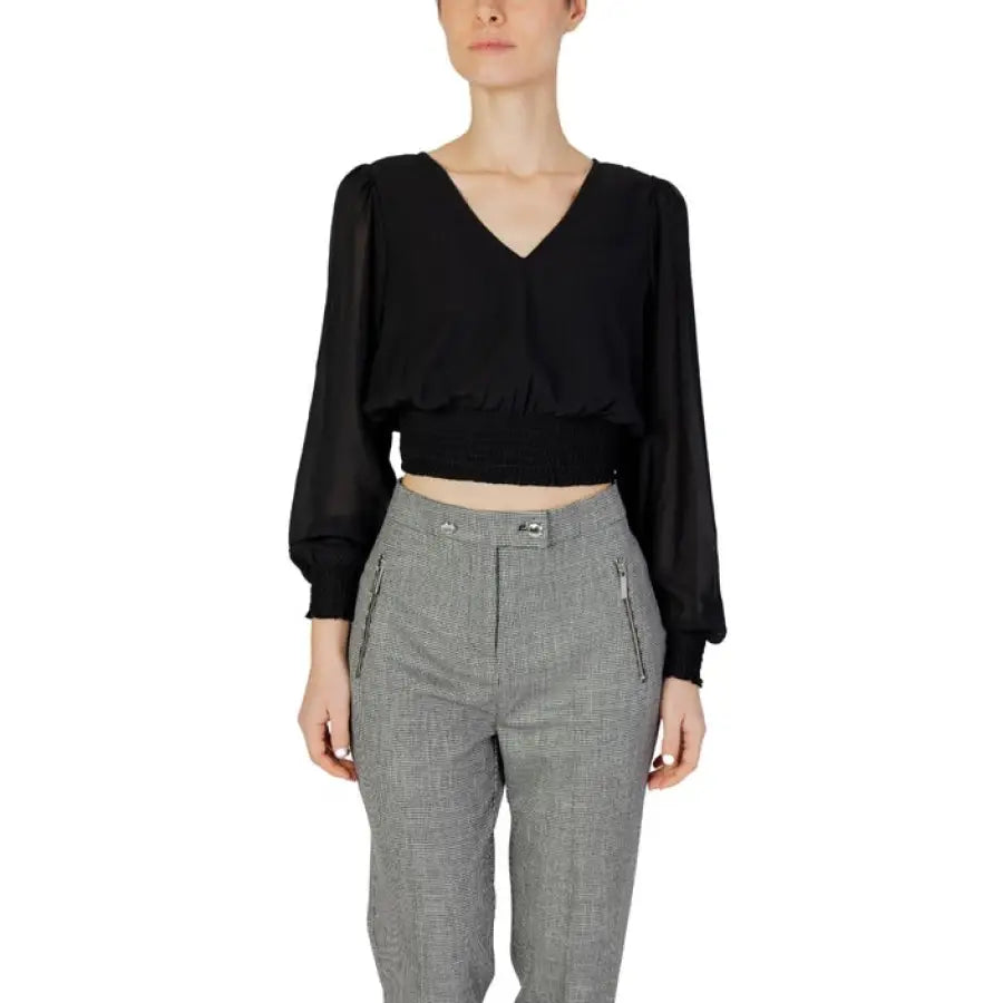 Woman in black Only women blouse and grey pants showcasing urban city fashion