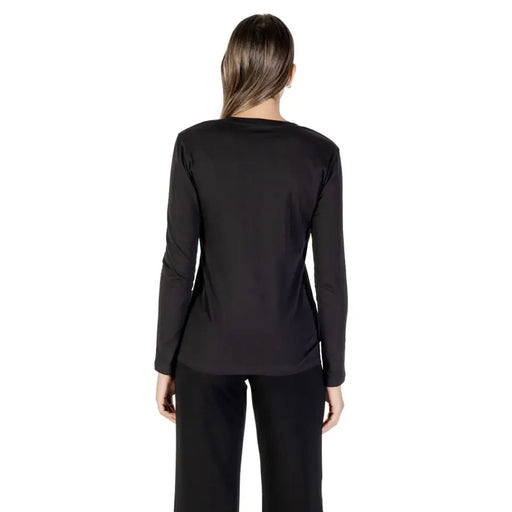 Woman wearing Armani Exchange black long sleeve round neck cotton T shirt
