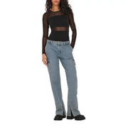 Woman in black mesh long-sleeve top and light blue cargo pants showcasing bodysuit