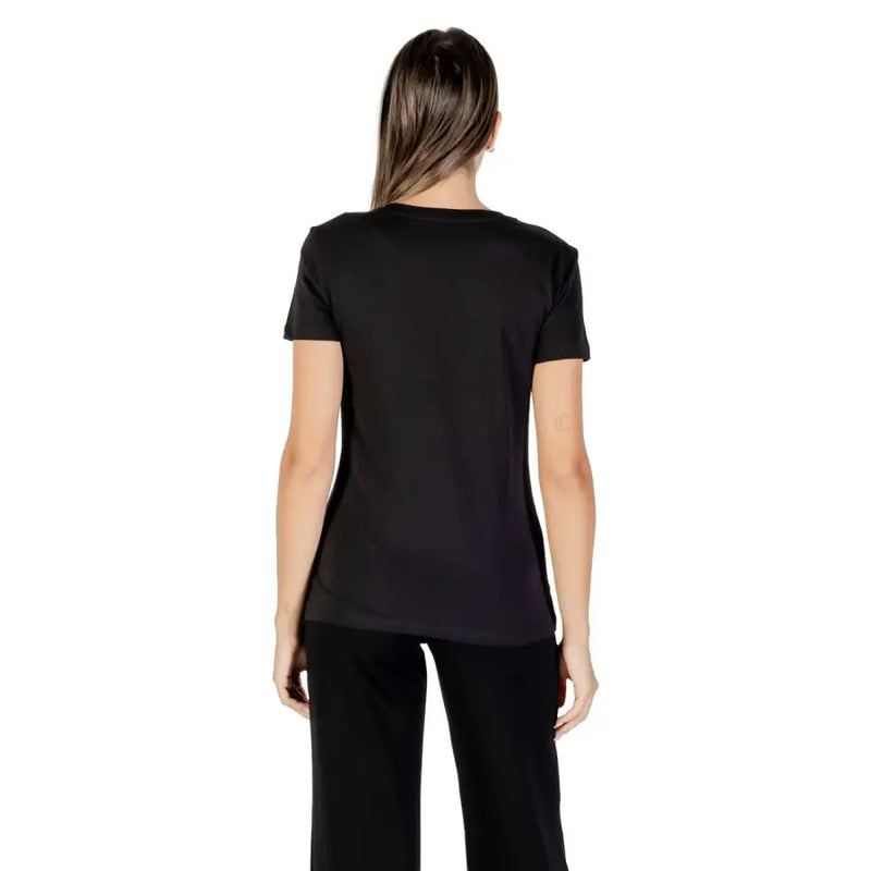 Woman wearing Armani Exchange Womens Black Rhinestone Cotton Tee with black pants