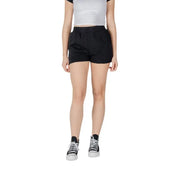 Woman wearing black shorts and black and white Converse sneakers for Women’s Black Converse Shorts and Sneakers product