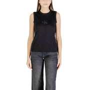 Woman wearing Calvin Klein Jeans black cotton sleeveless round neck tank top and dark wide-leg jeans