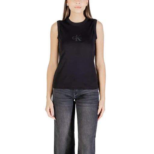 Woman wearing Calvin Klein Jeans black cotton sleeveless round neck tank top and dark wide-leg jeans