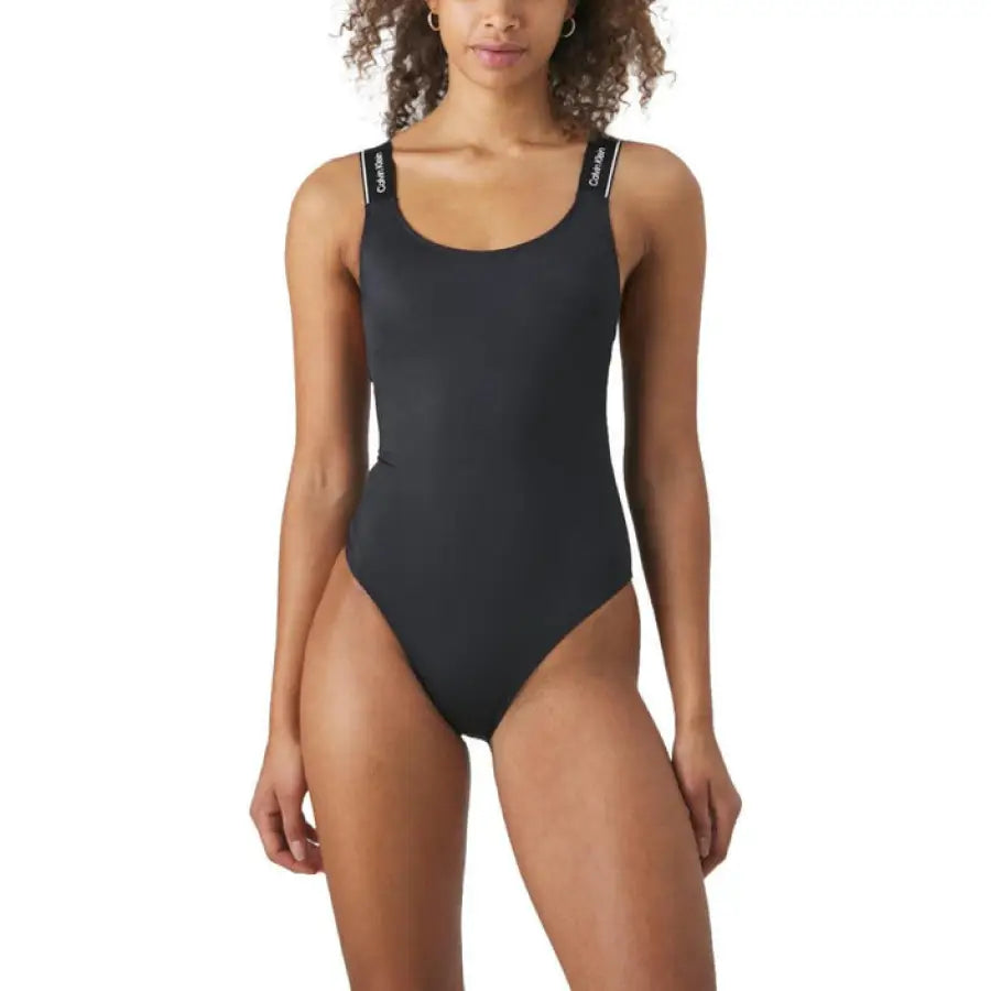 Woman in black Calvin Klein swimsuit, urban beachwear style