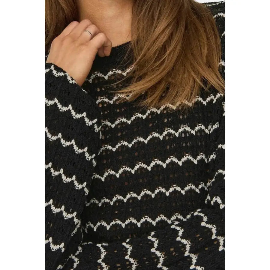 
                      
                        Woman in black and white sweater from Only Women Knitwear, showcasing urban city fashion
                      
                    