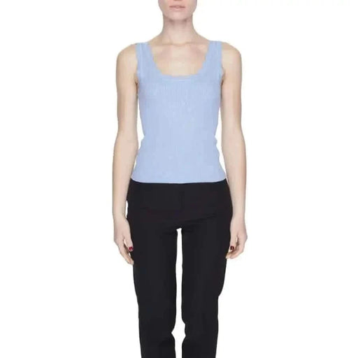 Woman in blue top, black pants showcasing Jacqueline De Yong urban style clothing