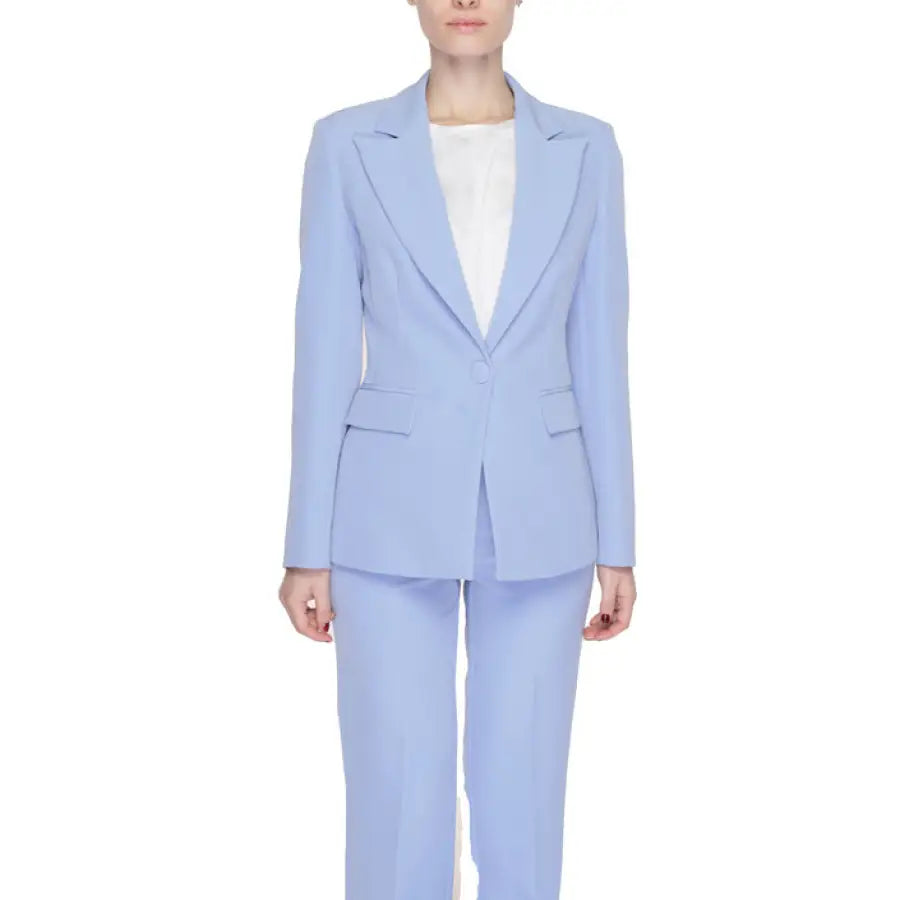 A woman in a blue Silence - Silence Women Blazer, showcasing urban style and sophistication