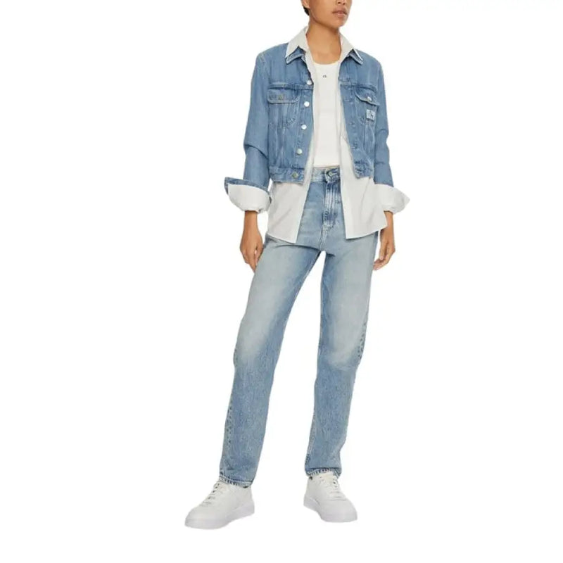 Woman wearing light blue denim jeans and denim jacket showcasing casual style