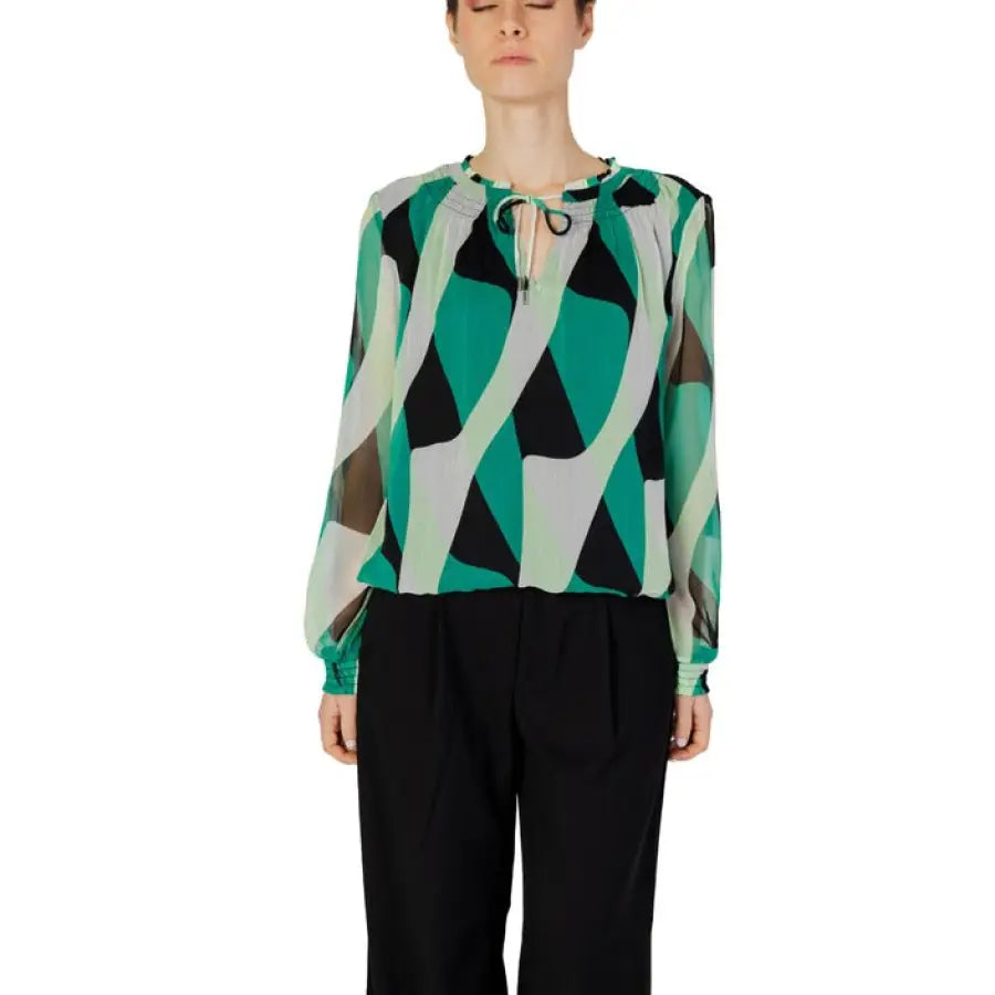 
                      
                        Woman in green and black Street One blouse, urban style clothing for modern women
                      
                    