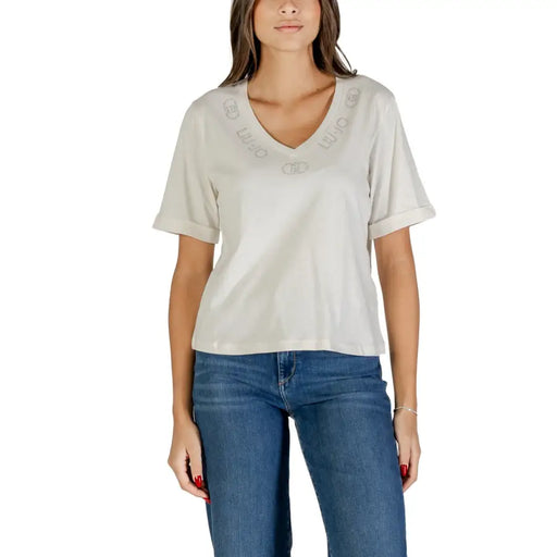 Woman wearing Liu Jo Black V Neck T Shirt with Rhinestone Print and blue jeans
