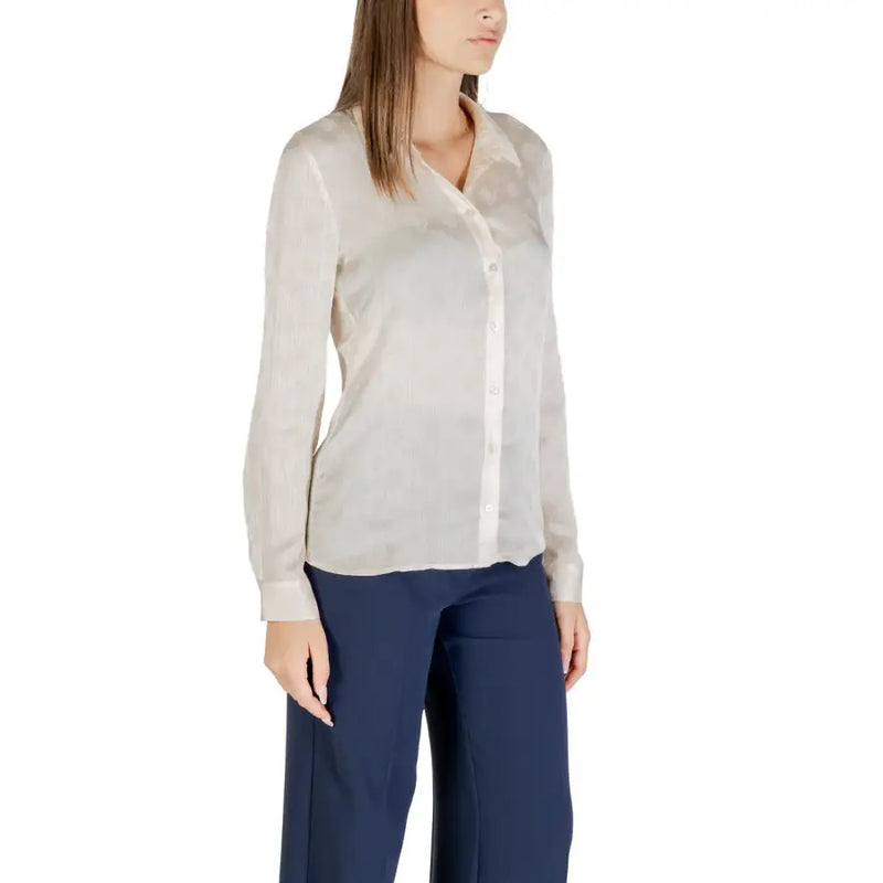 Woman wearing Beige Classic Long Sleeve Round Neck Shirt by Guess with dark blue trousers