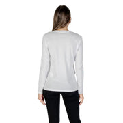 Woman modeling Armani Exchange white long sleeve T-shirt with rhinestone print and black pants