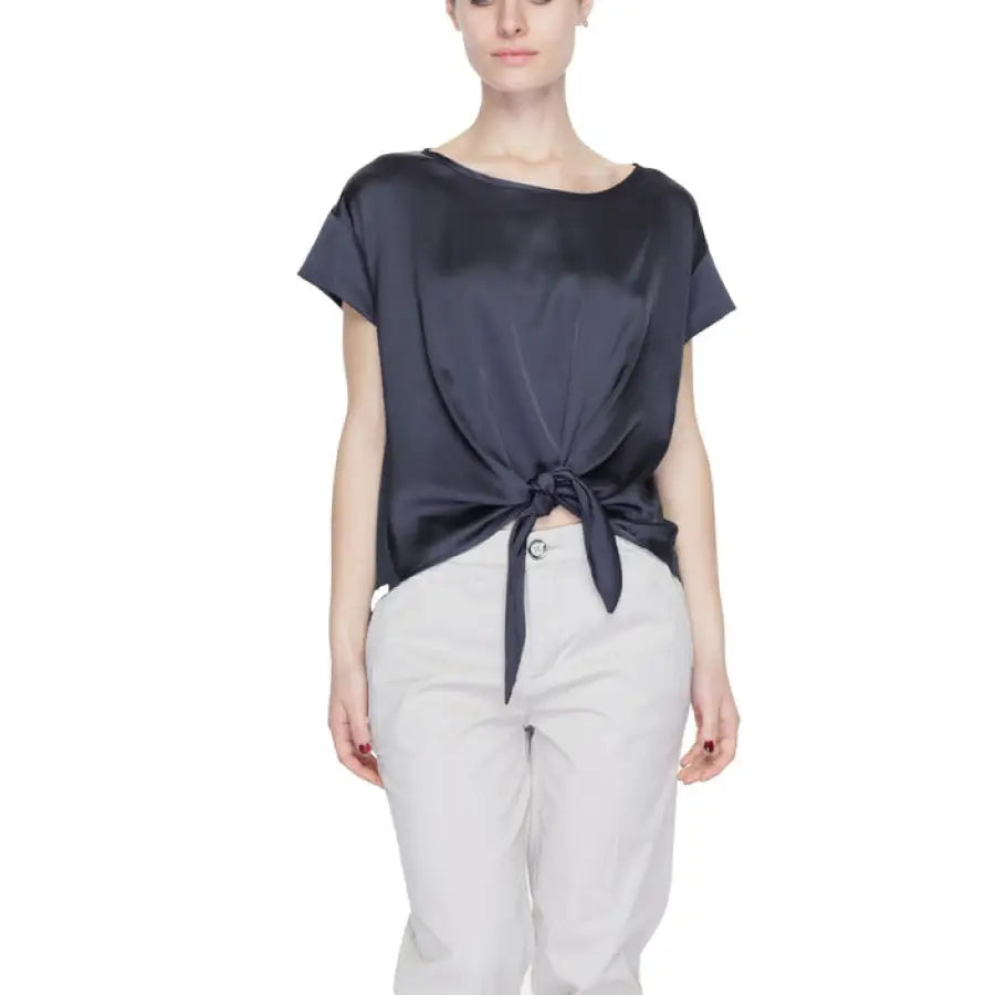 A woman wearing a navy top with a bow - Sandro Ferrone women blouse, urban chic fashion