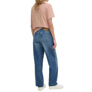 Woman wearing peach T-shirt and blue denim jeans from Women Casual Denim Jeans and T Shirt Collection