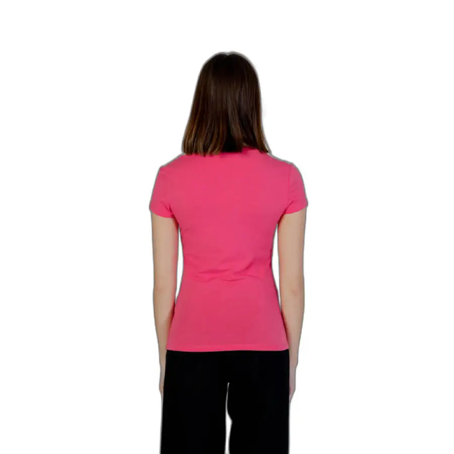 Armani Exchange woman in pink T-Shirt against white background
