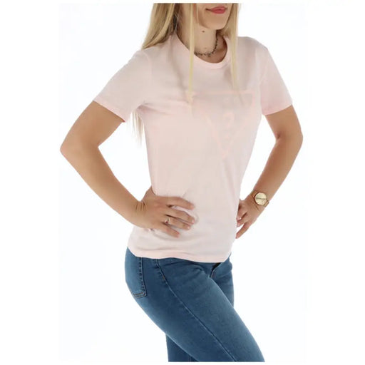 Woman wearing a pink T-shirt and blue jeans, showcasing casual fashion style