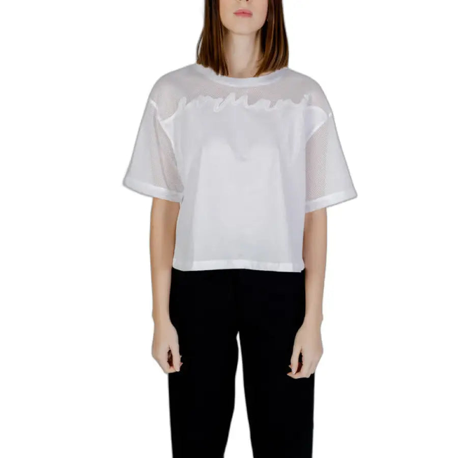 Armani Exchange woman in white blouse and black pants for Armani Exchange T-Shirt