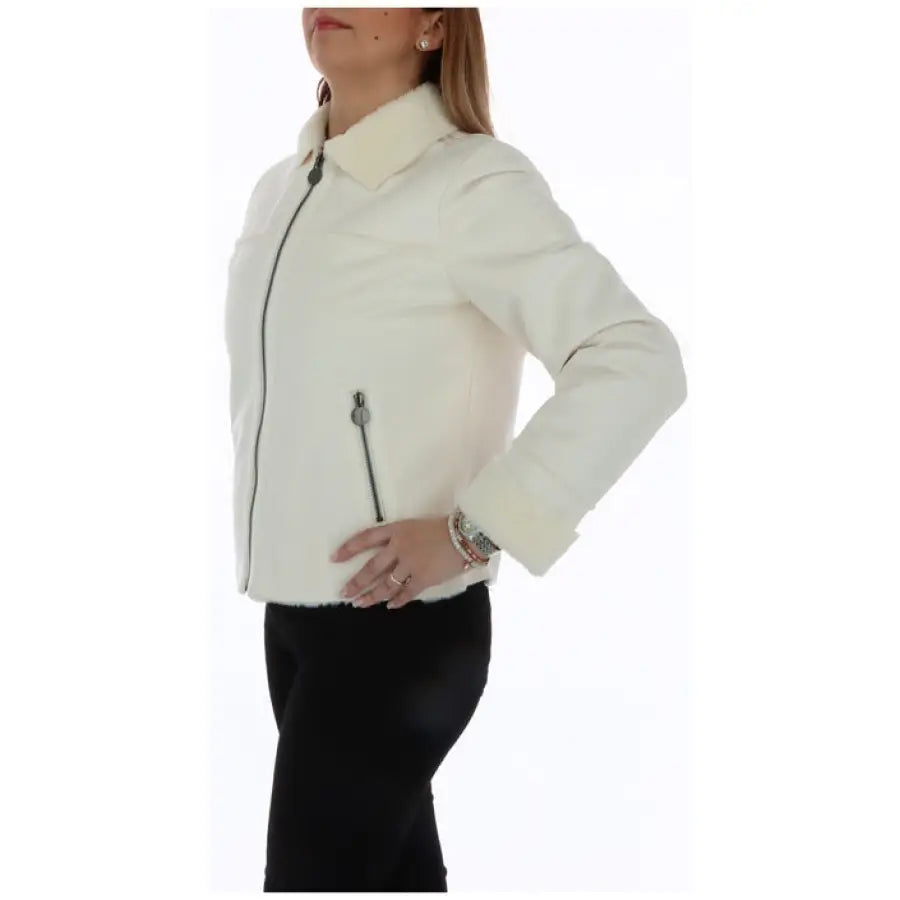 Woman in Diana Gallesi white jacket and black pants - urban style blazer for women