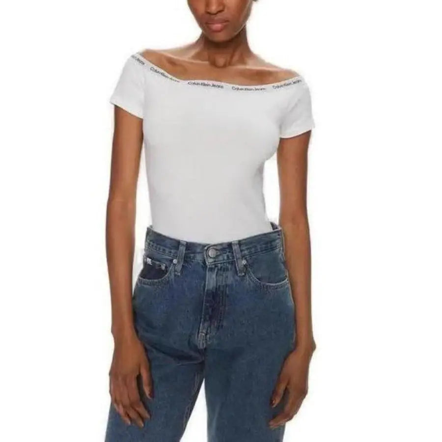 
                      
                        Calvin Klein Jeans women’s t-shirt with model wearing white top and jeans
                      
                    