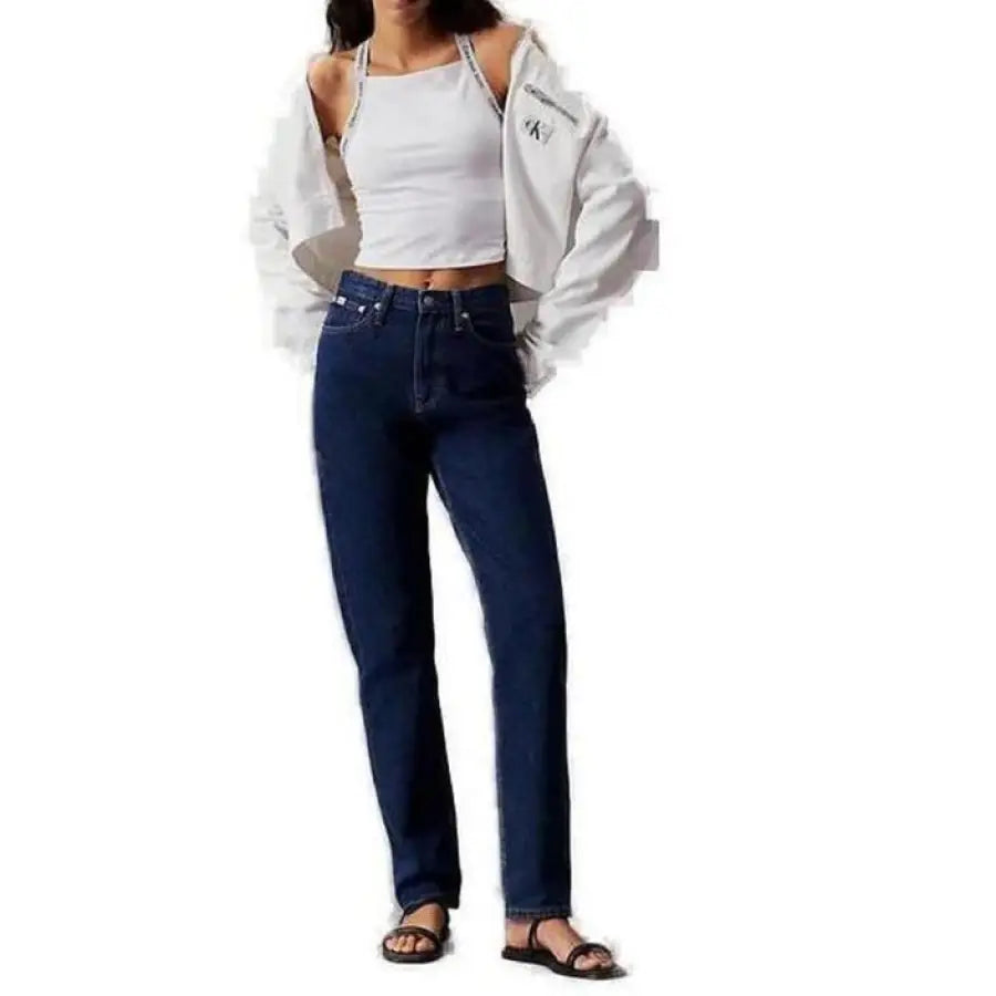 
                      
                        Woman in Calvin Klein jeans and white top showcasing Calvin Klein Women Undershirt
                      
                    